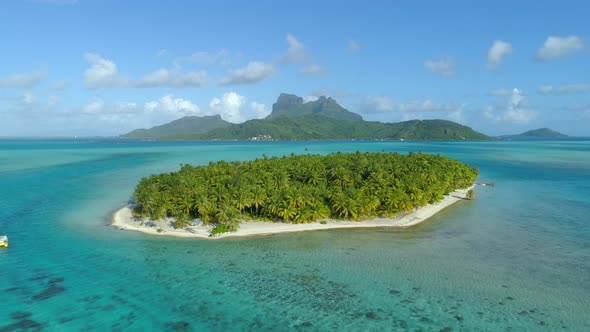 Aerial drone view of a deserted island near Bora Bora tropical island