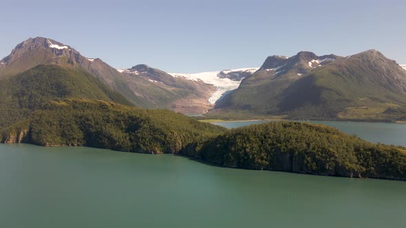 Aerial View Of Green Islands In Helgeland Coast With Svartisen Glacier In The Background