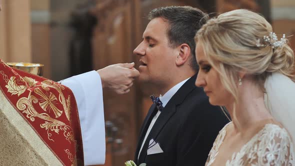 The Bride and Groom Take Communion in the Catholic Church