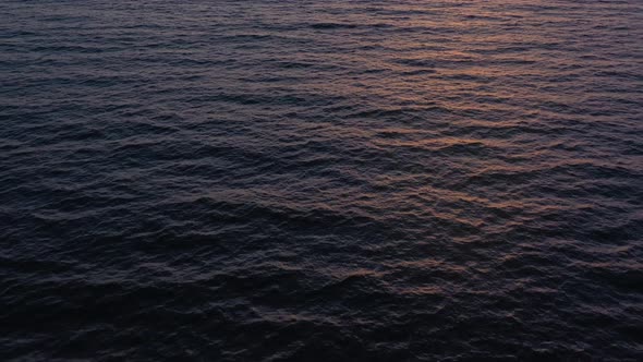 Aerial View of Surface of the Atlantic Ocean on the Background of a Beautiful Sunset