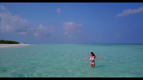 Girl happy and smiling on exotic bay beach time by blue green lagoon with white sandy background of 