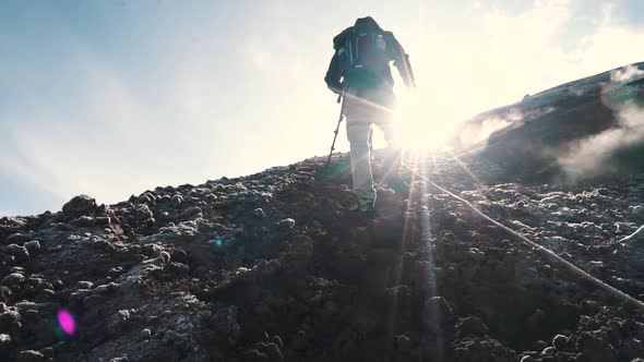 Slow Motion of Hiker Man Hiking on the Rocks in the Mountains in a Cold Day in Spring or Summer