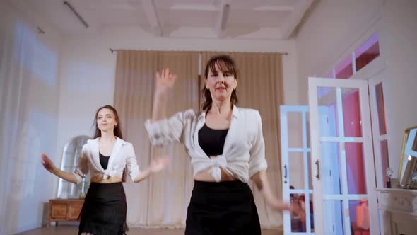 Girls in Black Skirts are Dancing in the Studio