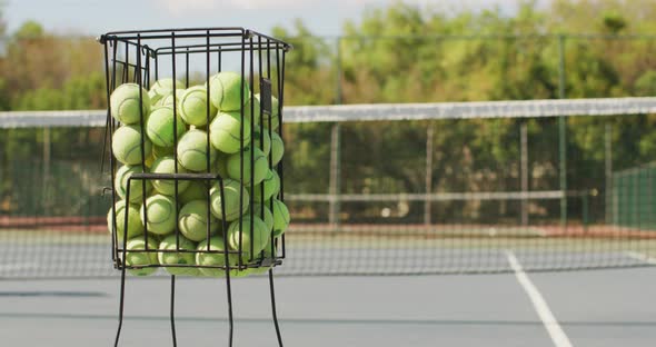 Video of basket with tennis balls on tennis court