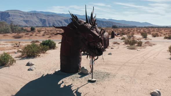 Girl Touching Metal Sculpture of Dragon in Anza Borrego Desert