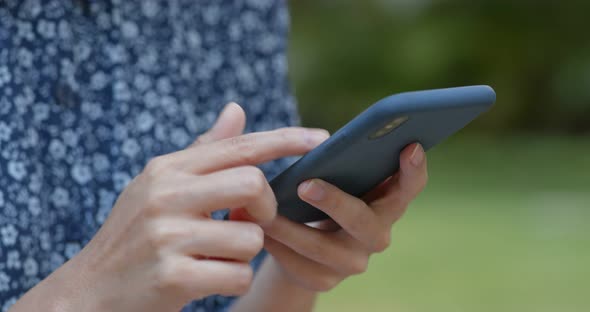 Woman use of mobile phone in park