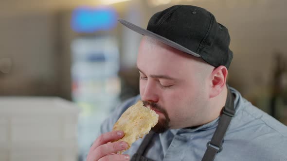 Closeup Face of Satisfied Pizza Chef Smelling Baked Dough