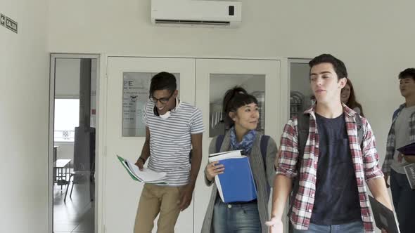 Group of college students walking in corridor