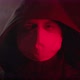 A Man in a Hood and a Medical Mask Looks Into the Camera - VideoHive Item for Sale