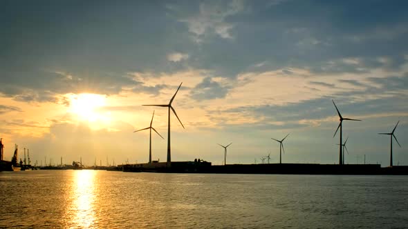 Wind Turbines in Antwerp Port on Sunset.