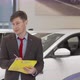 Mature Salesman Helping Male Customer Choosing Automobile to Buy - VideoHive Item for Sale