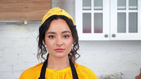 Close Up Serious Beautiful Housewife Looking Camera in Home Modern Kitchen