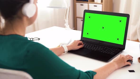 Woman with with Green Screen on Laptop at Home