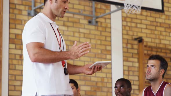 Basketball coach interacting with players