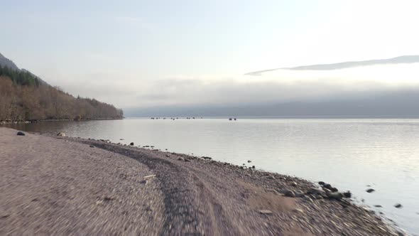 A Team of Canoeists Traversing a Lake in the Early Morning