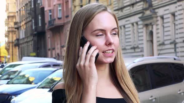 Young Beautiful Woman Phone in the City - Street in the Background