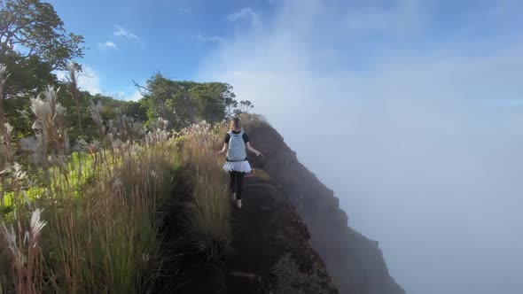 Woman Hiking By Steep Slope in Cloud at Sunset Outdoor Hawaii Island Nature