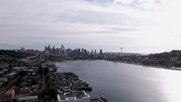 The bright sun reflecting off a panoramic view of Lake Union and downtown Seattle, aerial