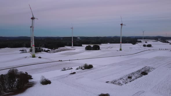 Aerial view of a wind farm in winter. Aerial view of rotating wind turbines.