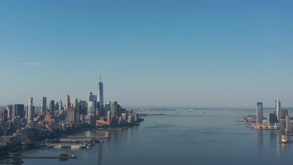 A drone view over the Hudson River early in the morning. The camera truck right and boom down over t