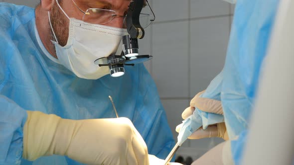 Professional Dental Surgeons and Assistant Operating Surgery Case of Broken Jaw in Operating Room at