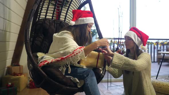 Two Girls Give Gifts To Each Other on New Year's Eve