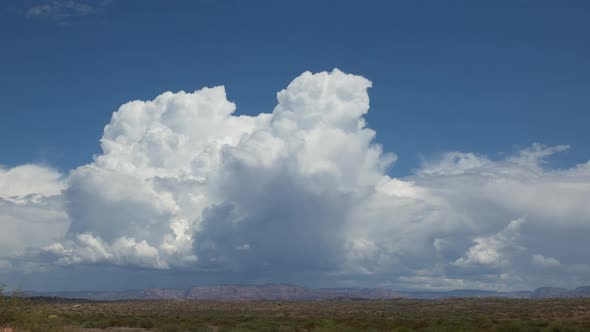 Bubbling Cumulus Clouds in High Desert Landscape Zoom Out Timelapse