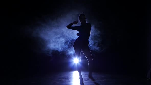 Dancing Girl Rumba in Studio, Silhouette. Blue Backlight