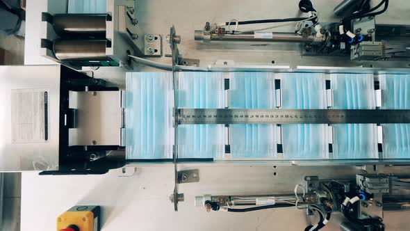 Top View of Face Masks Moving Along a Conveyor Belt at a Face Mask Factory