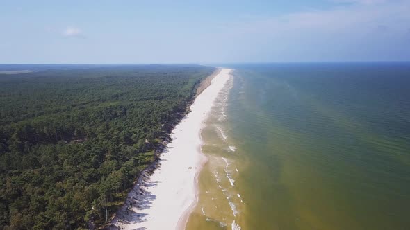 Drone footage of a sandy beach, sunny summer day, Baltic Sea, Poland, Lubiatowo.