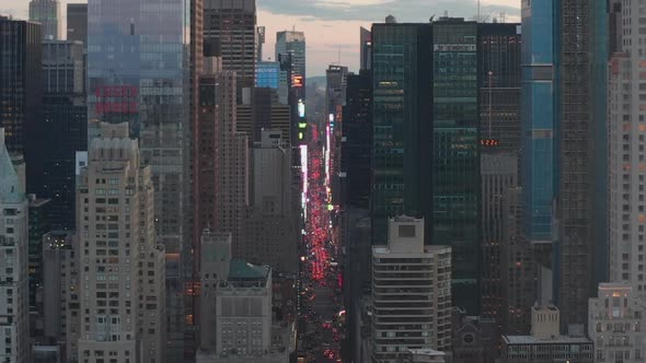 AERIAL: View of 7Th Avenue Traffic and Times Square Over New York City Central Park at Sunset with