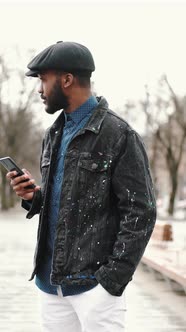Stylish African Young Man Outside with His Smartphone