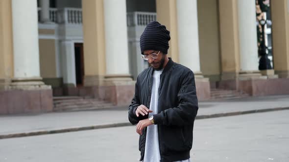 Serious Man with Glasses and a Hat Looking at the Camera in Slow Motion