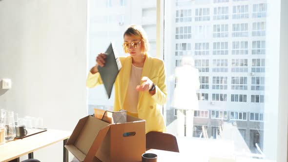 Young Employee Collects Things in a Box After Being Fired