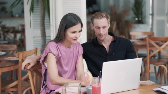 Guy and Girl in Stylish Cafe, Use Laptop, Drink Coffee, Laugh, Funny Video