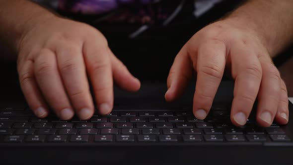 Man hands typing on laptop keyboard.