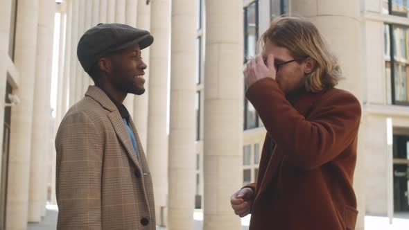 Two Diverse Businessmen Speaking on Street in Downtown