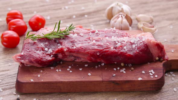 Cooking Concept. Raw Beef Steak on a Wooden Table