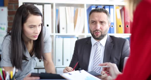 Man Boss at the Table Talking to Women