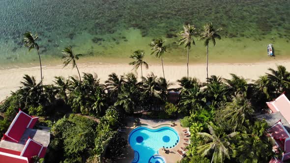 Oriental Houses on Seashore. Drone View of Lovely Oriental Cottages and Green Coconut Palms Located