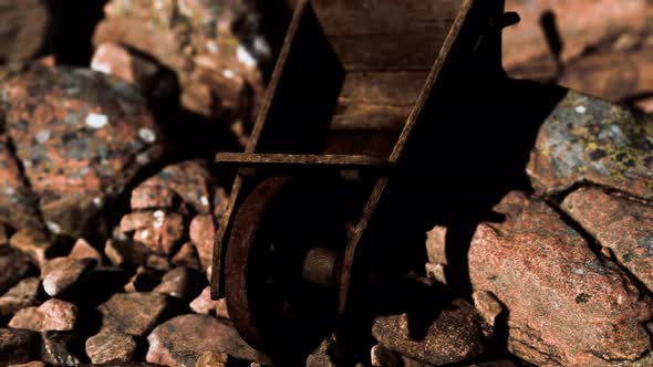 Abandoned Wooden Mine Wheelbarrow on Rocks