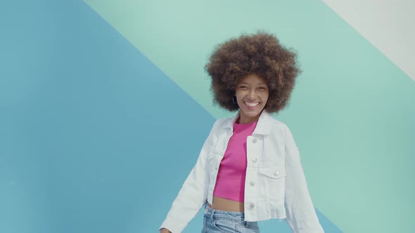 Beautiful young woman with curly hairstyle and fashionable clothes