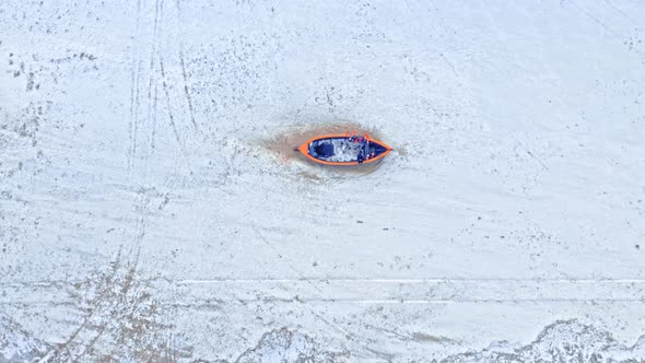 Boat on snowy beach, Baltic sea. Aerial view of winter.