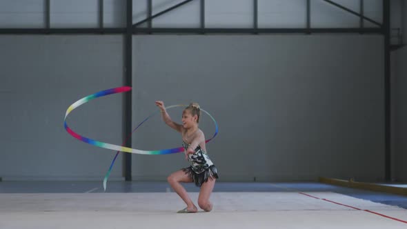 Teenage female gymnast performing at sports hall