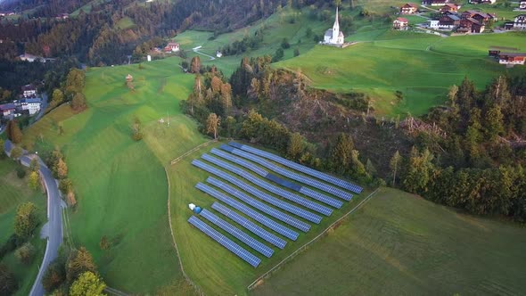 Aerial View of Solar Panels on Green Hills