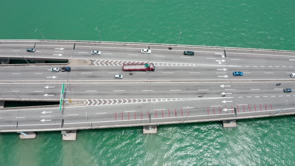 Penang Bridge Malaysia aerial side view with traffic lanes merging in both directions, drone bird's