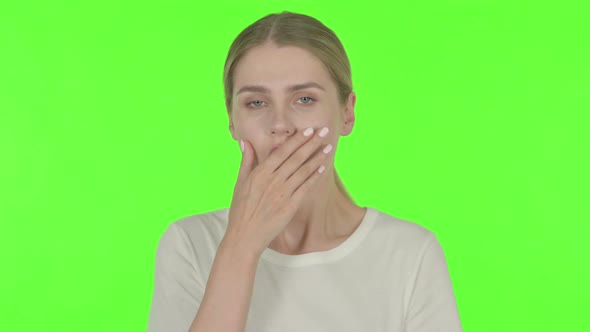 Shocked Young Woman by Loss on Green Background
