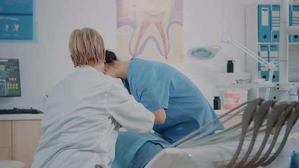 Dentist and Assistant Doing Oral Care Procedure on Patient