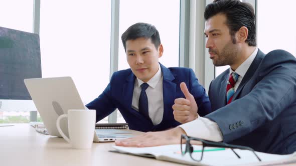 Two Business People Talk Project Strategy at Office