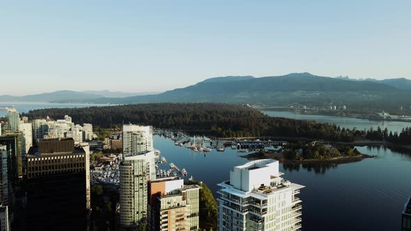 aerial drone footage of downtown Vancouver buildings and a beautiful view of Stanley Park. (British
